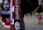 Flags showing Manchester City's manager Pep Guardiola and Manchester United's manager Jose Mourinho hang for sale ahead of the English League Cup soccer match between Manchester United and Manchester City at Old Trafford stadium in Manchester, Wednesday, Oct. 26, 2016. (AP Photo/Dave Thompson)