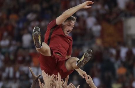 Roma's Francesco Totti is tossed in the air by his teammates after an Italian Serie A soccer match between Roma and Genoa at the Olympic stadium in Rome, Sunday, May 28, 2017. Francesco Totti played his final match with Roma against Genoa after a 25-season career with his hometown club. (AP Photo/Alessandra Tarantino) an Italian Serie A soccer match between Roma and Genoa at the Olympic stadium in Rome, Sunday, May 28, 2017. Francesco Totti is playing his final match with Roma against Genoa after a 25-season career with his hometown club. (AP Photo/Alessandra Tarantino)