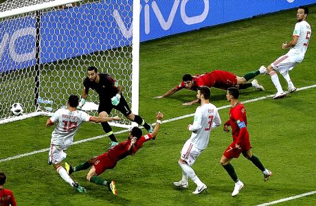 Spain's Diego Costa, left, scores his side's 2nd goal during the group B match between Portugal and Spain at the 2018 soccer World Cup in the Fisht Stadium in Sochi, Russia, Friday, June 15, 2018. (AP Photo/Thanassis Stavrakis)
