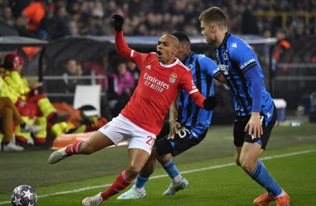 Benfica's Joao Mario, left, challenges for the ball with Brugge's Bjorn Meijer, right, and Brugge's Raphael Onyedika during the Champions League round of 16 first leg soccer match between Club Brugge and Benfica at the Jan Breydel stadium in Bruges, Belgium, Wednesday, Feb. 15, 2023. (AP Photo/Geert Vanden Wijngaert)