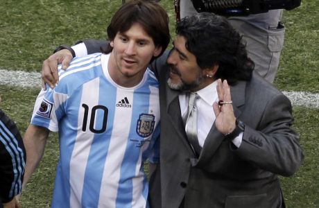 FILE.- In this June 17, 2010 file photo, Argentina head coach Diego Maradona, right, and Argentina's Lionel Messi, left ,walk off the pitch after the World Cup group B soccer match between Argentina and South Korea at Soccer City in Johannesburg, South Africa. The Argentine soccer great who was among the best players ever and who led his country to the 1986 World Cup title died from a heart attack on Wednesday, Nov. 25, 2020, at his home in Buenos Aires. He was 60. (AP Photo/Marcio Jose Sanchez, File)