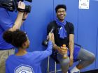 Kentucky's Nick Richards, right, reacts to a question from 10-year-old Elaijah Mayhorn during the university's NCAA college basketball media, Thursday, Oct. 11, 2018, in Lexington, Ky. (AP Photo/James Crisp)