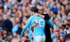 Manchester City's head coach Pep Guardiola hugs Jack Grealish before he replaces teammate Phil Foden during the English Premier League soccer match between Manchester City and Nottingham Forest at Etihad stadium in Manchester, England, Saturday, Sept. 23, 2023. (AP Photo/Jon Super)