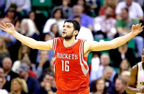 Houston Rockets' Kostas Papanikolaou celebrates after hitting a 3-point shot in the first half during an NBA basketball game against the Utah Jazz, Wednesday, Oct. 29, 2014, in Salt Lake City. (AP Photo/Rick Bowmer)