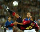 FC Barcelona's Brazilian player Rivaldo scores his third goal against Valencia, as Ruben Baraja (back) looks on, during their Spanish first division soccer match in Barcelona Nou Camp stadium, June 17, 2001.  Rivaldo's hat-trick earned Barcelona a 3-2 win and a place in the Champions League next season.  REUTERS/Albert Gea