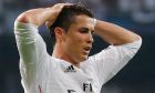 Real Madrid's Cristiano Ronaldo grabs his head after missing a chance to score during the Champions League second leg semifinal soccer match between Real Madrid and Juventus, at the Santiago Bernabeu stadium in Madrid, Wednesday, May 13, 2015. The match ended in a 1-1 draw, Juventus won on aggregate and will play Barcelona in the Champions League final on June 6, 2015 in Berlin. (AP Photo/Daniel Ochoa de Olza)