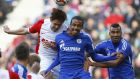 Augsburg's Hong Jeong-ho from South Korea, left, Schalke's Eric Maxim Choupo-Moting from Cameroon, right, and Schalke's Joel Matip from Cameroon challenge for the ball during the German first division Bundesliga soccer match between FC Augsburg and FC Schalke 04 in the SGL Arena in Augsburg, Germany, on Sunday, April 5, 2015. (AP Photo/Matthias Schrader)