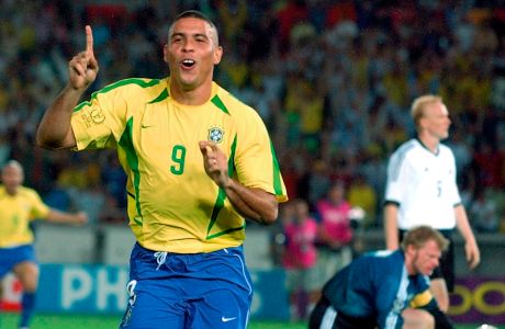 FILE - In this June 30, 2002,  file photo, Brazil's Ronaldo reacts after scoring past Germany's goalkeeper Oliver Kahn, center, and Carsten Ramelow during their 2002 World Cup final soccer match, at the Yokohama stadium in Yokohama, Japan. On this day: Brazil wins its fifth World Cup as Ronaldo strikes twice to defeat Germany 2-0. (AP Photo/Dusan Vranic, File)
