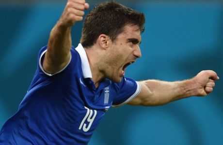 Greece's defender Sokratis Papastathopoulos celebrates after scoring during a Round of 16 football match between Costa Rica and Greece at Pernambuco Arena in Recife during the 2014 FIFA World Cup on June 29, 2014.             AFP PHOTO / PEDRO UGARTE        (Photo credit should read PEDRO UGARTE/AFP/Getty Images)