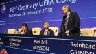 UEFA General Secretary Theodore Theodoridis, UEFA President Aleksander Ceferin and UEFA Vice President Reinhard Grindel, from left, wait for the start of the 42nd ordinary UEFA congress in Bratislava, Slovakia, Monday, Feb. 26, 2018. (AP Photo/Ronald Zak)