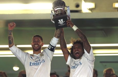Real Madrid's captain Sergio Ramos, left, and Marcelo lift up the trophy after winning the Spanish Super Cup against Barcelona at the Santiago Bernabeu Stadium in Madrid, Thursday, Aug. 17, 2017. Real Madrid won 5-1 on aggregate. (AP Photo/Francisco Seco)