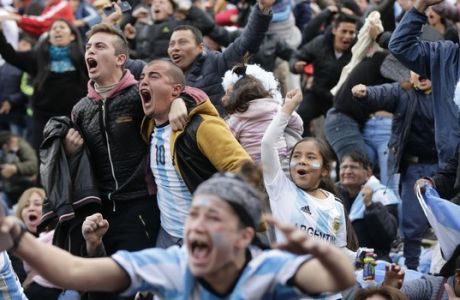 In this Tuesday, June 26, 2018 photo, Argentina soccer fans celebrate Argentina's goal by Marcos Rojo during a live broadcast of the Russia 2018 World Cup soccer match against Nigeria, in Buenos Aires, Argentina. (AP Photo Jorge Saenz)