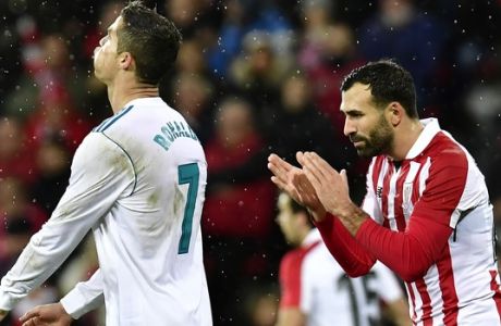 Real Madrid's Cristiano Ronaldo, left, laments missing a goal beside Athletic Bilbao's Mikel Balenziaga, during the Spanish La Liga soccer match between Athletic Bilbao and Real Madrid at San Mames stadium, in Bilbao, northern Spain, Saturday, Dec. 2, 2017. Real Madrid tied the mach 0-0. (AP Photo/Alvaro Barrientos)