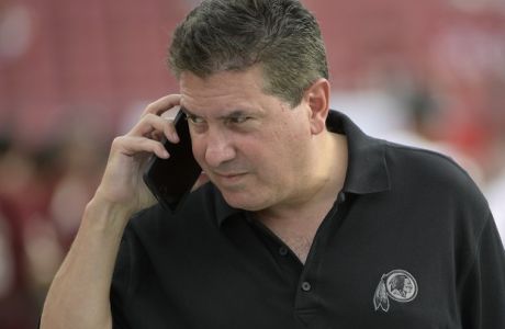 Washington Redskins owner Daniel Snyder talks on a phone on the field before an NFL preseason football game against the Tampa Bay Buccaneers Thursday, Aug. 31, 2017, in Tampa, Fla. (AP Photo/Phelan M. Ebenhack)