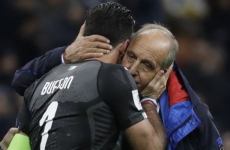 Italy goalkeeper Gianluigi Buffon is comforted by Italy coach Gian Piero Ventura after Italy failed to qualify at the end of the World Cup qualifying play-off second leg soccer match between Italy and Sweden, at the Milan San Siro stadium, Italy, Monday, Nov. 13, 2017. (AP Photo/Luca Bruno)
