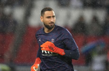 PSG's goalkeeper Gianluigi Donnarumma runs out to warm-up before the French League One soccer match between Paris Saint-Germain and Lyon at the Parc des Princes in Paris Sunday, Sept. 19, 2021. (AP Photo/Francois Mori)