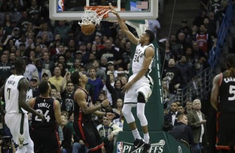 Milwaukee Bucks' Giannis Antetokounmpo dunks during the first half of Game 4 of an NBA first-round playoff series basketball game against the Toronto Raptors Saturday, April 22, 2017, in Milwaukee. (AP Photo/Morry Gash)