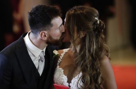 Newlyweds Lionel Messi and Antonella Roccuzzo kiss while posing for photographers on the red carpet after tying the knot in Rosario, Argentina, Friday, June 30, 2017. About 250 guests, including teammates and former teammates of the Barcelona star, attended the highly anticipated ceremony. (AP Photo/Victor R. Caivano)