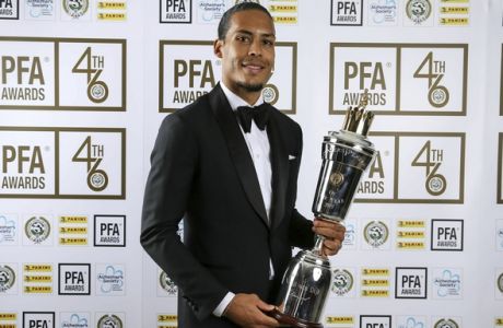 Liverpool's Virgil van Dijk holds the PFA Player of the Year award during the 2019 PFA Awards at the Grosvenor House Hotel, London, Sunday April 28, 2019. Virgil van Dijk has been voted English soccer's player of the year in recognition of his commanding performances in Liverpool's defense as it bids to win the top-flight title for the first time since 1990. (Barrington Coombs/PA via AP)