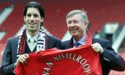 Dutch PSV Eindhoven player Ruud van Nistelrooy, left, with his new manager Sir Alex Ferguson, holds up the shirt he will wear next season at the Manchester United soccer ground in Manchester England Friday, April 27, 2001. The 25 year old Dutch international has signed a five-year contract with the English champions for a record 19 million pounds (dlrs 27 million). (AP Photo/Max Nash)