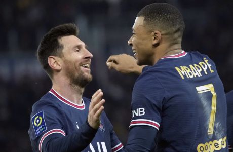 PSG's Kylian Mbappe, centre, celebrates with PSG's Lionel Messi after scoring his side's second goal during the French League One soccer match between Paris Saint-Germain and Monaco at the Parc des Princes stadium in Paris, France, Sunday, Dec. 12, 2021. (AP Photo/Christophe Ena)