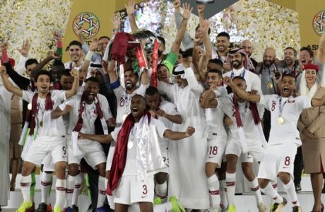 Qatar's forward Hasan Al Haydos, center, lifts the trophy for the winners of the AFC Asian Cup final match between Japan and Qatar in Zayed Sport City in Abu Dhabi, United Arab Emirates, Friday, Feb. 1, 2019. (AP Photo/Hassan Ammar)