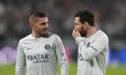 PSG's Lionel Messi, right, speaks with his teammate Marco Verratti during the warm up prior to the Champions League group H soccer match between Juventus and Paris Saint Germain at the Allianz stadium in Turin, Italy, Wednesday, Nov. 2, 2022. (AP Photo/Antonio Calanni)