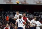 Arsenal's Shkodran Mustafi, center, heads the ball to score his side's opening goal during the English Premier League soccer match between Arsenal and Tottenham Hotspur at Emirates stadium in London, Saturday, Nov. 18, 2017. (AP Photo/Kirsty Wigglesworth)