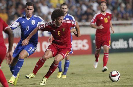 Cyprus' Pieros Sotiriou, left, challengers for the ball with Belgium's Alex Witsel during the Euro 2016 qualifying Group B match between Cyprus and Belgium, at GSP stadium, in Nicosia, Cyprus, Sunday, Sept. 6, 2015. (AP Photo/Petros Karadjias)