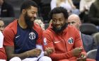 Washington Wizards guard John Wall, right, smiles next to Markieff Morris on the bench during the first half of the team's NBA exhibition basketball game against the Guangzhou Long-Lions, Friday, Oct. 12, 2018, in Washington. (AP Photo/Nick Wass)