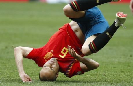 Spain's Andres Iniesta falls during the round of 16 match between Spain and Russia at the 2018 soccer World Cup at the Luzhniki Stadium in Moscow, Russia, Sunday, July 1, 2018. (AP Photo/Matthias Schrader)