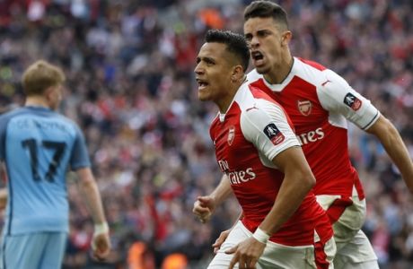 Arsenal's Alexis Sanchez, center, celebrates after scoring his side's second goal during the English FA Cup semifinal soccer match between Arsenal and Manchester City at Wembley stadium in London, Sunday, April 23, 2017. (AP Photo/Kirsty Wigglesworth)