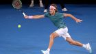 Greece's Stefanos Tsitsipas makes a forehand return to Switzerland's Roger Federer during their fourth round match at the Australian Open tennis championships in Melbourne, Australia, Sunday, Jan. 20, 2019. (AP Photo/Aaron Favila)