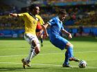 BELO HORIZONTE, BRAZIL - JUNE 14:  Juan Guillermo Cuadrado of Colombia and Sokratis Papastathopoulos of Greece battle for the ball during the 2014 FIFA World Cup Brazil Group C match between Colombia and Greece at Estadio Mineirao on June 14, 2014 in Belo Horizonte, Brazil.  (Photo by Ian Walton/Getty Images)