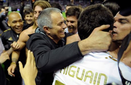 Real Madrid's coach coach Jose Mourinho from Portugal, center, celebrates with his team after they won the Spanish League during their Spanish La Liga soccer match, against Athletic Bilbao, at San Mames stadium in Bilbao, northern Spain, Wednesday, May 2, 2012. (AP Photo/Alvaro Barrientos)