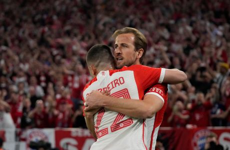 Bayern's Harry Kane, right, celebrates with his teammate Raphael Guerreiro after scoring his side's second goal during the Champions League semifinal first leg soccer match between Bayern Munich and Real Madrid at the Allianz Arena in Munich, Germany, Tuesday, April 30, 2024. (AP Photo/Matthias Schrader)