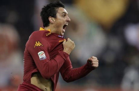 AS Roma defender Nicolas Burdisso, of Argentina, celebrates after scoring during a Serie A soccer match between AS Roma and AC Milan, at Rome's Olympic stadium, Saturday, Dec. 22, 2012. (AP Photo/Andrew Medichini)