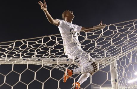 David Braz of Santos celebrates at end of the final match of the Sao Paulo State soccer league against Palmeiras in Santos, Brazil, Sunday, May 3, 2015. Santos won in a penalty shootout after tying 2-2 on aggregate. (AP Photo/Andre Penner)