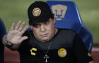 Dorados' head coach Diego Maradona waves as he takes his seat on the bench ahead of the start of Dorados' Copa MX quarterfinal match against Pumas at Olympic University Stadium in Mexico City, Tuesday, March 12, 2019. (AP Photo/Rebecca Blackwell)