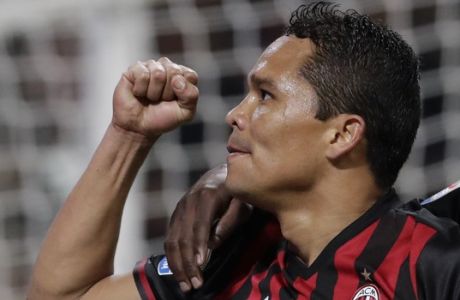 AC Milan's Carlos Bacca, left, celebrates with his teammate Gianluca Lapadula after scoring his side's second goal during a Serie A soccer match between AC Milan and Chievo Verona, at the San Siro stadium in Milan, Italy, Saturday, March 4, 2017. (AP Photo/Luca Bruno)