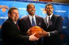 Newly named president of the New York Knicks Isiah Thomas, center, holds a ball with owner James Dolan, left, and president of sports operations Steve Mills during a news conference at Madison Square Garden Monday, Dec. 22, 2003. Scott Layden was fired Monday as president of the New York Knicks and Isiah Thomas was hired to replace him. (AP Photo/Gregory Bull)