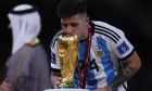 Argentina's Enzo Fernandez kisses the trophy after winning the World Cup final soccer match between Argentina and France at the Lusail Stadium in Lusail, Qatar, Sunday, Dec.18, 2022. (AP Photo/Manu Fernandez)