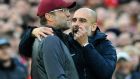 Manchester City manager Josep Guardiola, right, and Liverpool manager Juergen Klopp talk during the English Premier League soccer match between Liverpool and Manchester City at Anfield stadium in Liverpool, England, Sunday, Oct. 7, 2018. (AP Photo/Rui Vieira)