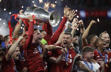 Liverpool's players celebrate with the trophy after winning the Champions League final soccer match between Tottenham Hotspur and Liverpool at the Wanda Metropolitano Stadium in Madrid on June 2, 2019. (AP Photo/Felipe Dana)