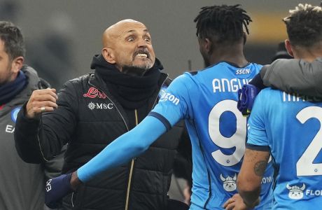 Napoli's head coach Luciano Spalletti, left, celebrates with team players as they won the Serie A soccer match between AC Milan and Napoli at the San Siro stadium in Milan, Italy, Sunday, Dec. 19, 2021. (AP Photo/Antonio Calanni)