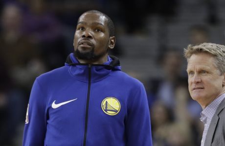 Golden State Warriors' Kevin Durant, left, and head coach Steve Kerr during the second half of an NBA basketball game against the Portland Trail Blazers Monday, Dec. 11, 2017, in Oakland, Calif. (AP Photo/Marcio Jose Sanchez)