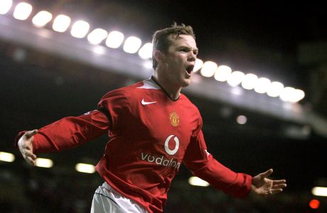 FILE - In this Saturday, Feb. 26, 2005 file photo, Manchester United's Wayne Rooney celebrates after scoring his second goal against Portsmouth during their English Premier League soccer match at Old Trafford Stadium, Manchester, England. Rooney now has the Derby job on a permanent basis after England's record goal-scorer received a contract through 2023 to manage the second division team and retired from playing, it was reported on Friday, Jan. 15, 2021. The 35-year-old former Manchester United captain, who took temporary charge in November of Derby, is now focusing on his coaching career. (AP Photo/Jon Super, File)