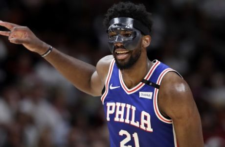 Philadelphia 76ers' Joel Embiid (21) reacts after scoring during the second half of Game 3 of a first-round NBA basketball playoff series against the Miami Heat, Thursday, April 19, 2018, in Miami. The 76ers won 128-108. (AP Photo/Lynne Sladky)
