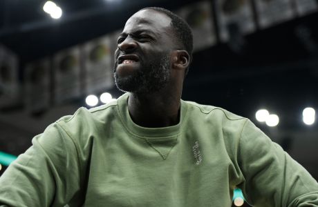 Golden State Warriors' Draymond Green celebrates on the bench during the final minutes of the team's NBA basketball game against the Chicago Bulls on Friday, Jan 12, 2024, in Chicago. The Warriors won 140-131. (AP Photo/Paul Beaty)