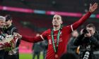 Liverpool's Kostas Tsimikas celebrates with the trophy after winning the English League Cup final soccer match between Chelsea and Liverpool at Wembley Stadium in London, Sunday, Feb. 25, 2024. (AP Photo/Alastair Grant)